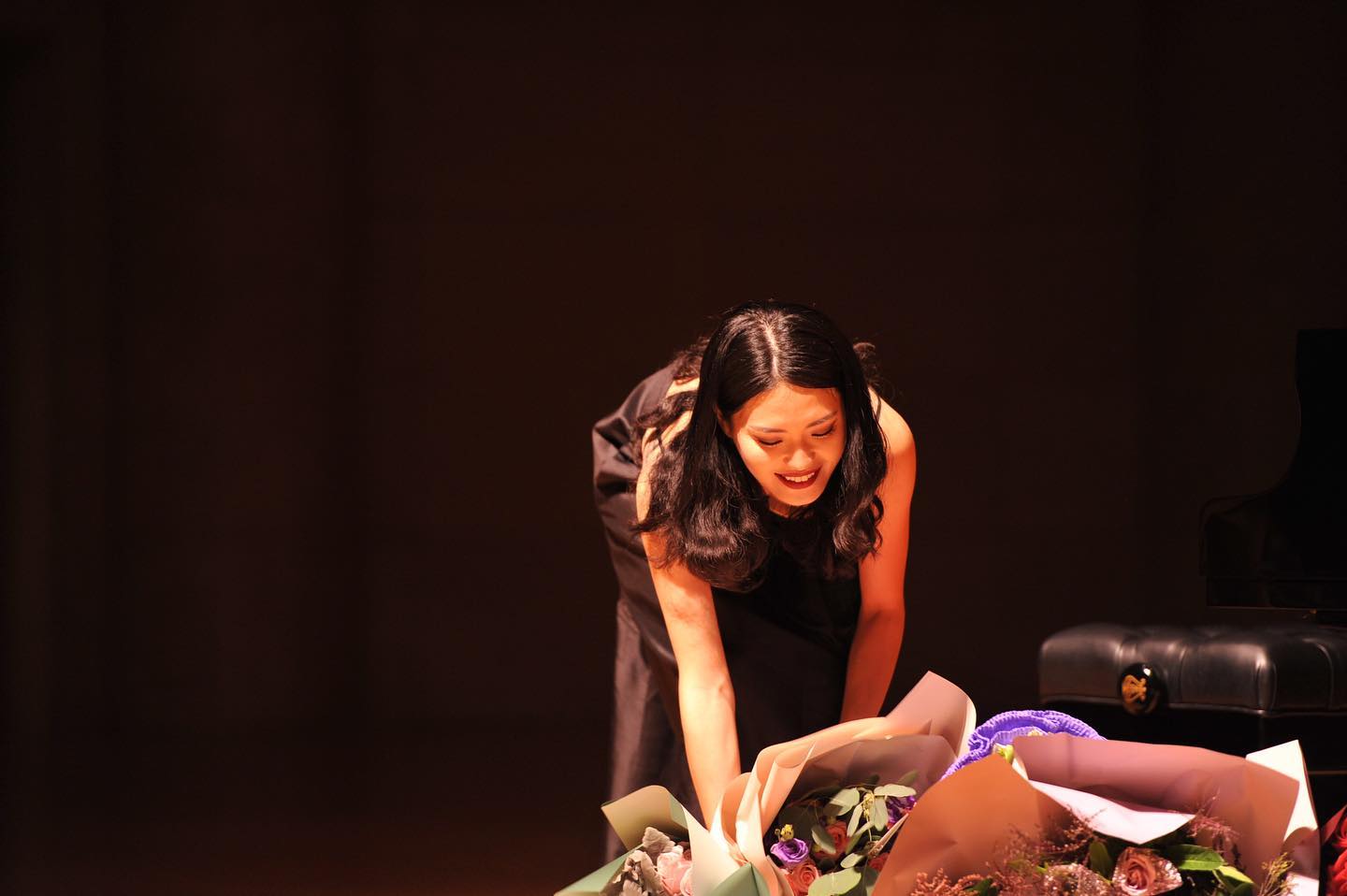 Tianyu receiving flowers after a performance