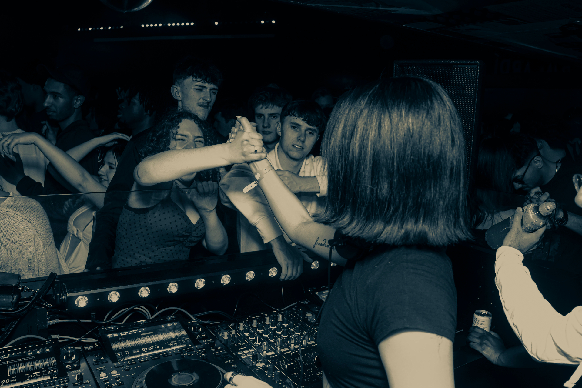 DJ Tianyu connecting with the crowd from the booth
